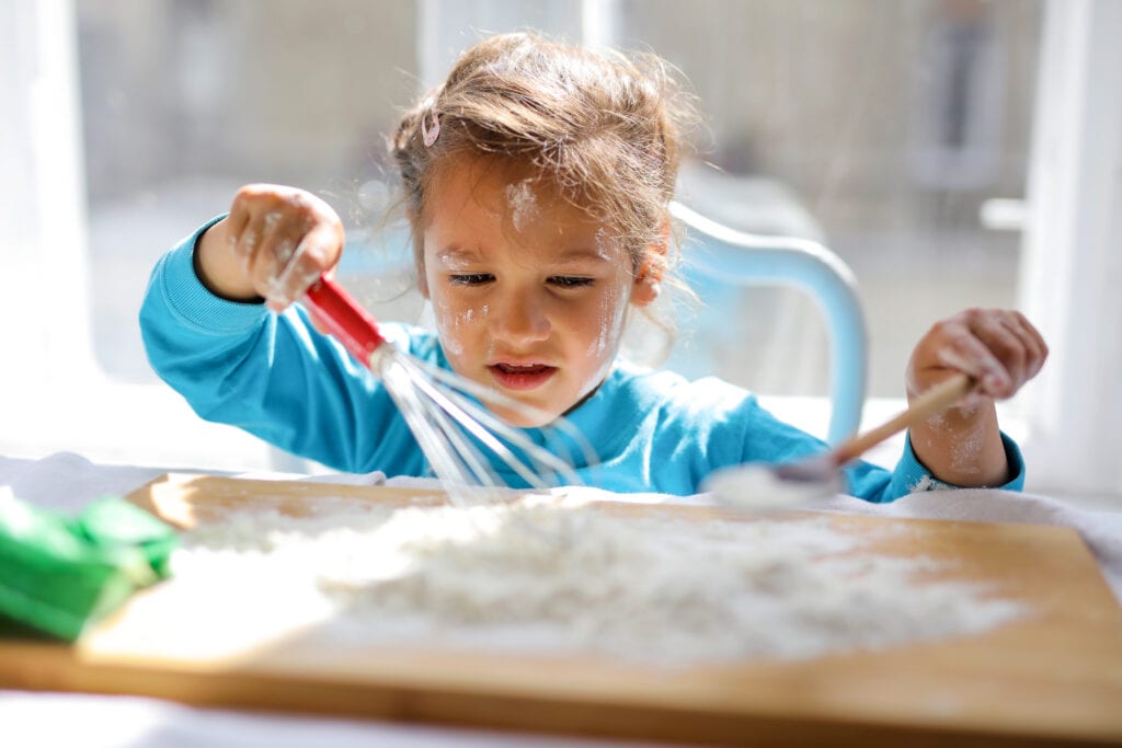 Canva - Girl Wearing Blue Top While Playing With Flour