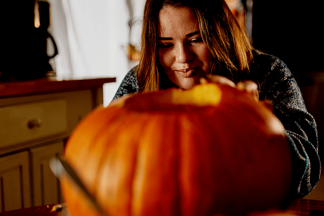 girl carving pumpkin 